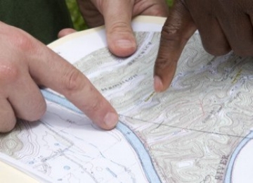 Forester pointing to map