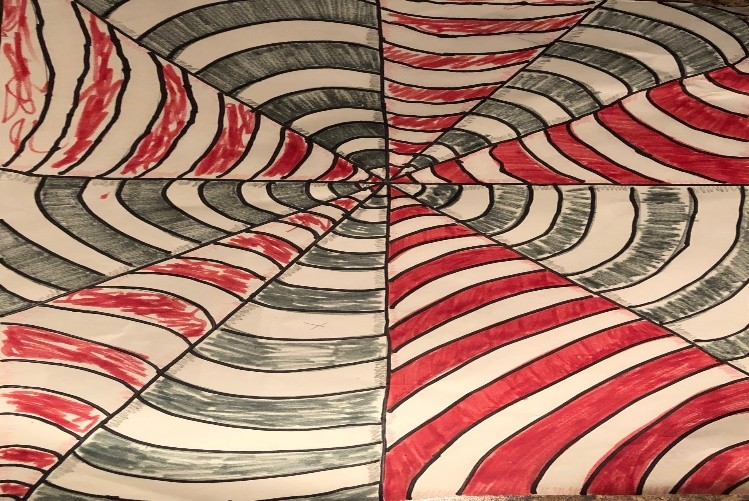 “Kinsley’s Web” by Kinsley Turner The drawing is divided diagonally from the center, with alternating sections of white and red thick stripes, and blue and white thick stripes. It appears to look like a red, white and blue web