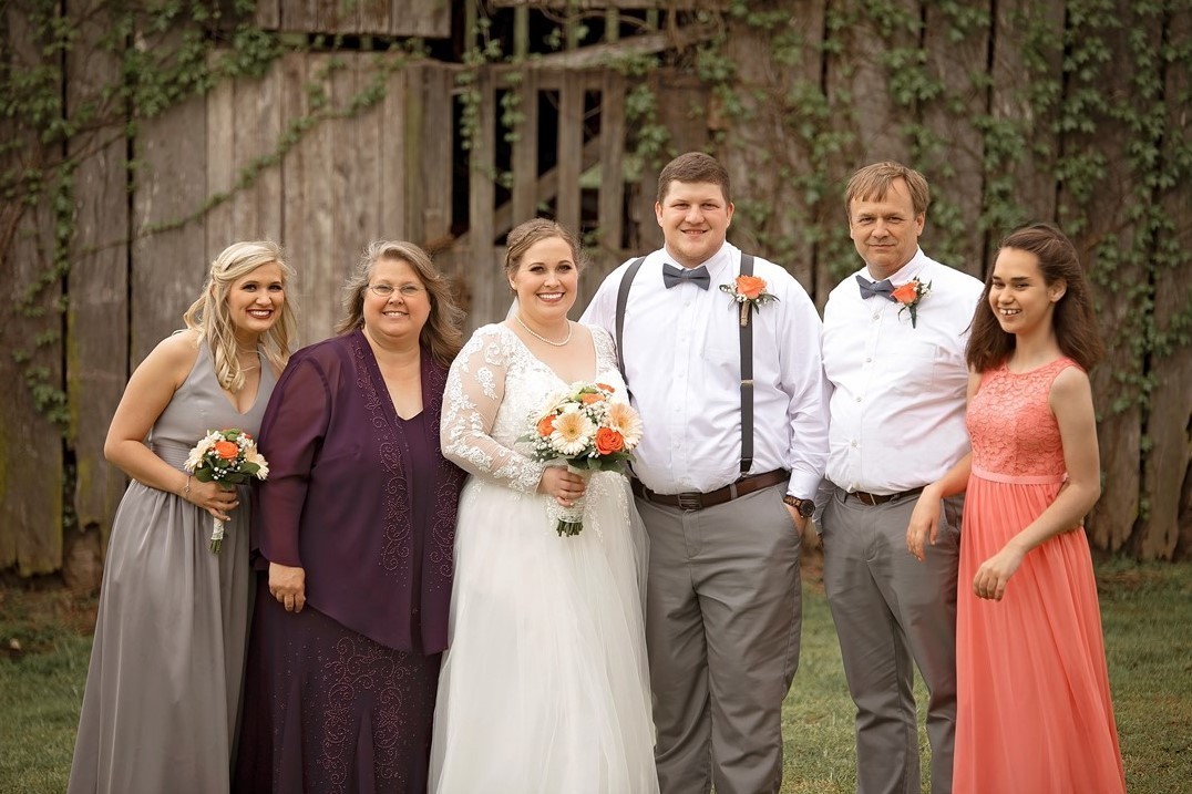 Chrissy Hood and family A family photo of the Hood family from a wedding – shows Chrissy, her husband, and three daughters