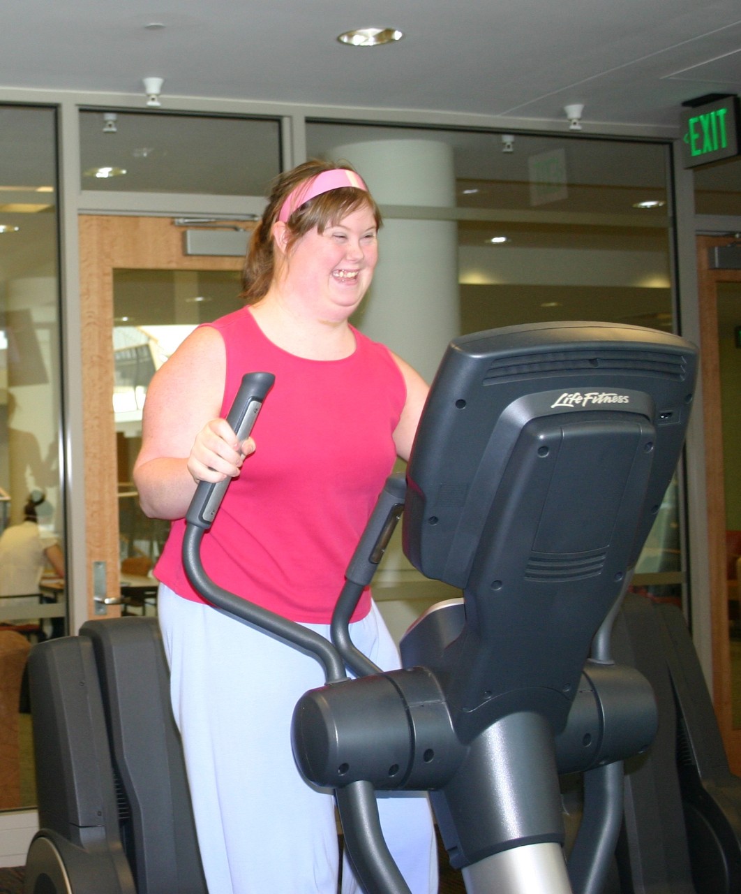 Jeanne Gavigan, Next Steps class of 2011 Jeanne Gavigan when she was at Next Steps, smiling and in bright pink workout clothes on a treadmill