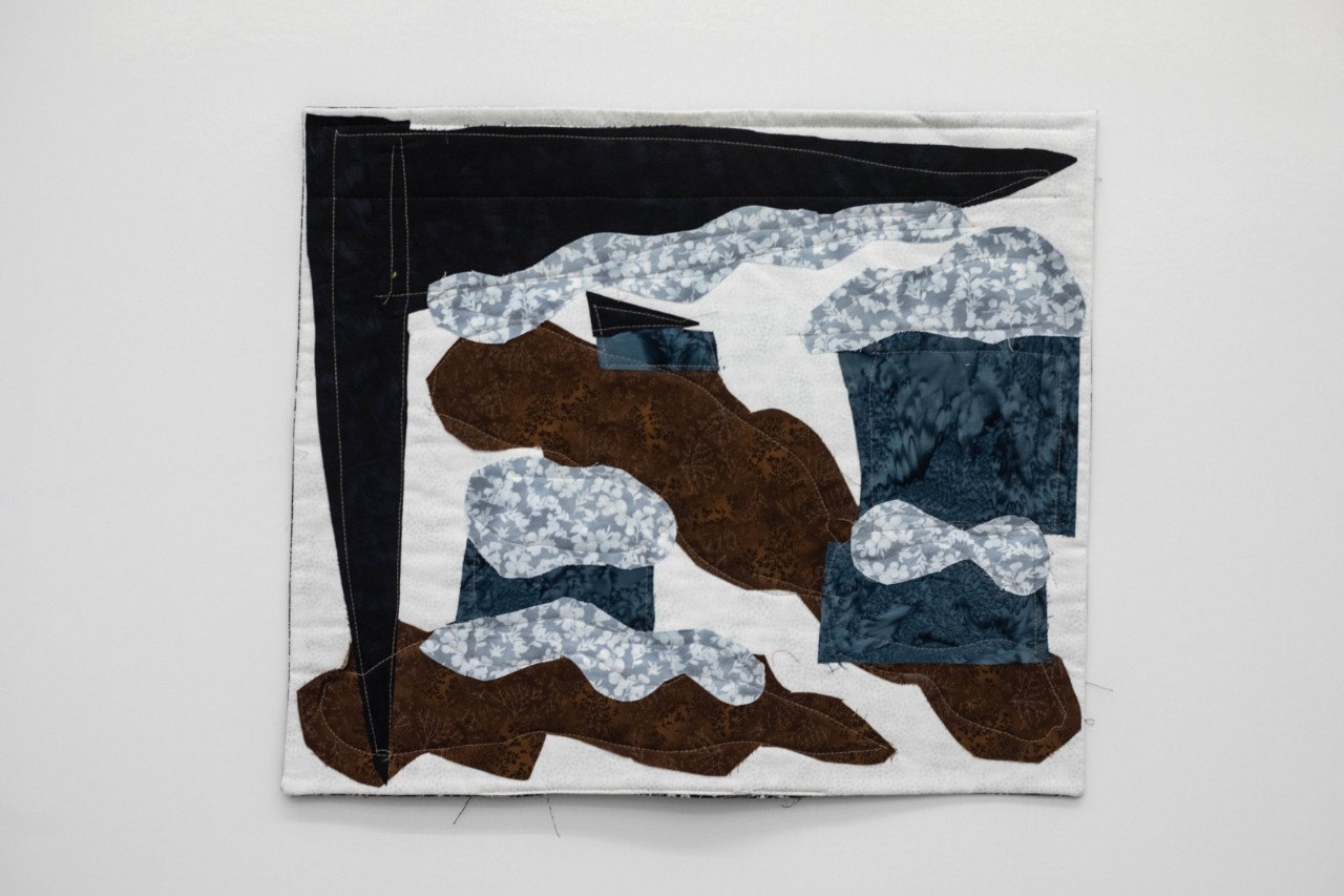 Hope McKee. Nashville Devastation, 2023. blue and white flowered or patterned fabric with dark blue fabric under it appears to represent rain and flooding, with swaths of brown fabric appearing to represent mud