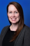 headshot of Ashley Edwards, a white woman with long brown hair, a black shirt and gray sweater