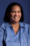 headshot of Mildred Sparkman, a Black woman with curly black ringlets and a blue blouse