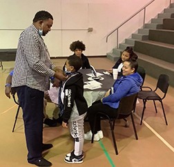 Photo from MLTC Ties With Dad event (male tying tie on juvenile male) Photo from MLTC Ties With Dad event (male tying tie on juvenile male)
