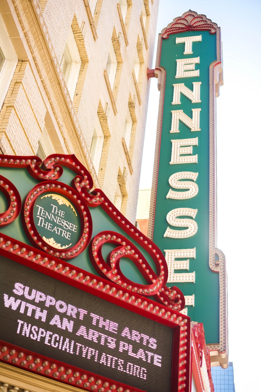 Lit up sign with show descriptions outside of the Tennessee Theatre