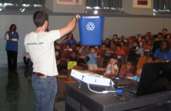 photo of blue recycling bin demonstration to students photo of blue recycling bin demonstration to students