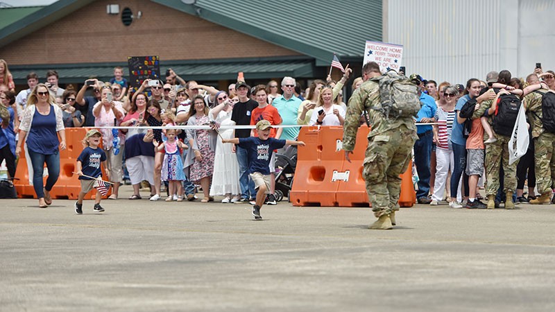 Tennessee Guard Unit Returns from Kosovo Children running on tarmac to their father, a Tennessee Soldier returning from deployment to Kosovo