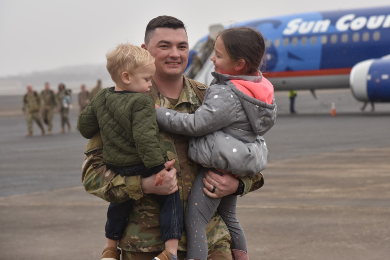 278th ACR Return from Poland Tennessee Soldier greets his children on airport runway