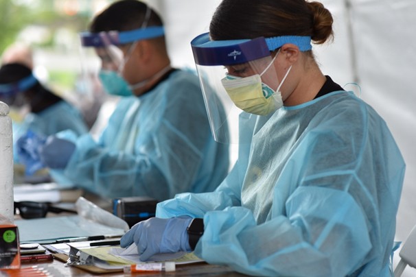 Pfc. Kathryn Ratliff works at the Nissan Stadium COVID-19 testing site, in downtown Nashville, Aug. 21. Soldier in personal protective gear working at covid-19 testing site