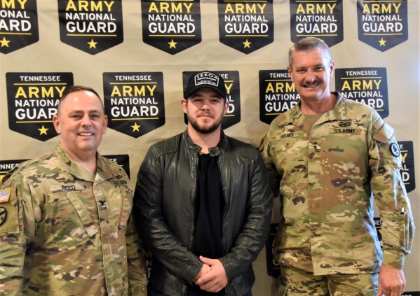 Columbia Nashville Recording Artist Kameron Marlowe takes a photograph with Maj. Gen. Jeff Holmes, Tennessee’s Adjutant General, and Col. James Reed, Tennessee National Guard’s Joint Chief of Staff, during a celebration for the National Guard’s 385th birthday at Smyrna’s Volunteer Training Site, Dec. 13. (Photo by retired Sgt. 1st Class Edgar Castro)