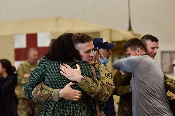 Sgt. Jacob Winton, 208th Medical Company (Area Support), embraces his loved ones during their departure ceremony at Smyrna’s Volunteer Training Site, Dec. 6. The 208th deployed for a yearlong mission to the Middle East in support of Operation Spartan Shield and Operation Inherent Resolve. (Photo by Sgt. 1st Class Timothy Cordeiro) Sgt. Jacob Winton, 208th Medical Company (Area Support), embraces his loved ones during their departure ceremony at Smyrna’s Volunteer Training Site, Dec. 6. The 208th deployed for a yearlong mission to the Middle East in support of Operation Spartan Shield and Operation Inherent Resolve. (Photo by Sgt. 1st Class Timothy Cordeiro)