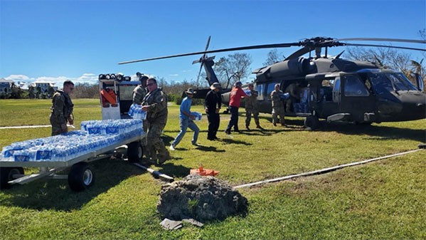 Crewmembers from the Tennessee National Guard’s 1-230th Assault Helicopter Battalion load bottled water on a Blackhawk helicopter for transport to victims of Hurricane Ian. Crews continue to ferry food, water, and other supplies to islands disconnected from the mainland since Ian made landfall last week. (Submitted photo) Crewmembers from the Tennessee National Guard’s 1-230th Assault Helicopter Battalion load bottled water on a Blackhawk helicopter for transport to victims of Hurricane Ian. Crews continue to ferry food, water, and other supplies to islands disconnected from the mainland since Ian made landfall last week. (Submitted photo)
