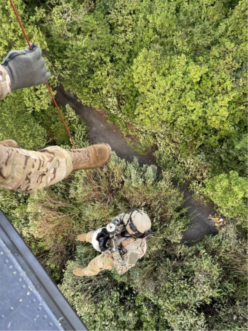 Tennessee National Guard crew chief, Sgt. Christopher Farrar, lowers the flight paramedic, Sgt. 1st Class Giovanni DeZuani, to an injured hiker during a rescue at the Great Smoky Mountains National Park, July 27. (Submitted photo) Tennessee National Guard crew chief, Sgt. Christopher Farrar, lowers the flight paramedic, Sgt. 1st Class Giovanni DeZuani, to an injured hiker during a rescue at the Great Smoky Mountains National Park, July 27. (Submitted photo)