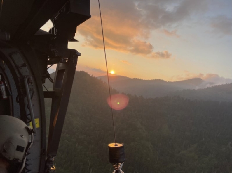 Sgt. Christopher Farrar, a crew chief with the Tennessee Army National Guard, prepares to hoist an injured hiker, who is immobilized and protected on a Skedco stretcher, into a hovering Blackhawk helicopter during a rescue at the Great Smoky Mountains National Park, July 27. (Submitted photo) Sgt. Christopher Farrar, a crew chief with the Tennessee Army National Guard, prepares to hoist an injured hiker, who is immobilized and protected on a Skedco stretcher, into a hovering Blackhawk helicopter during a rescue at the Great Smoky Mountains National Park, July 27. (Submitted photo)