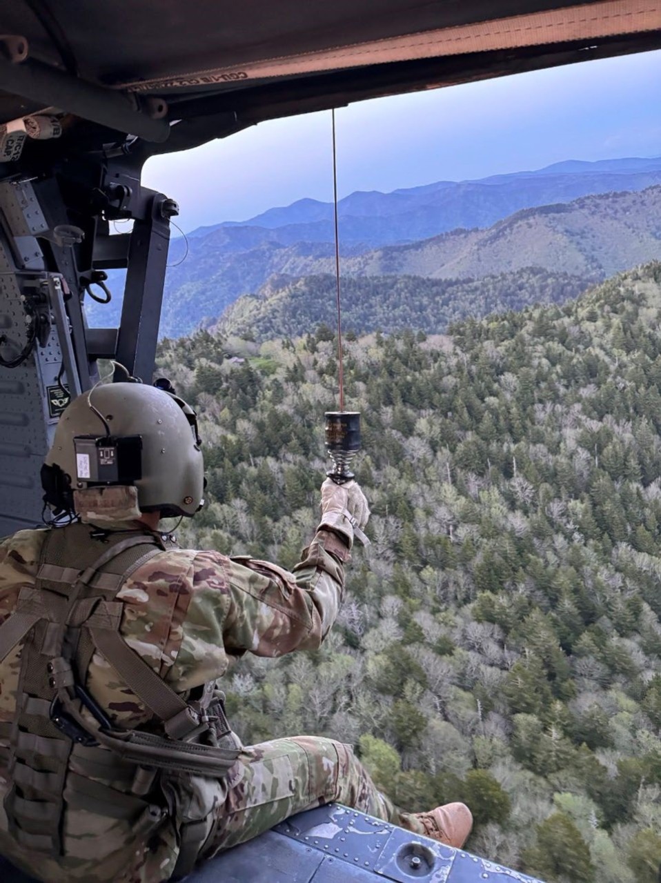 Sgt. 1st Class Cassandra Antes, a paramedic assigned to Task Force Smokey, prepares to be hoisted down to rescue a hiker in need of medical assistance, May 20, in the Great Smoky Mountains National Park. (courtesy photo)